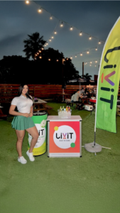 Promotoras en activación BTL nocturna con publicidad inflable y dinámica de marca en evento al aire libre