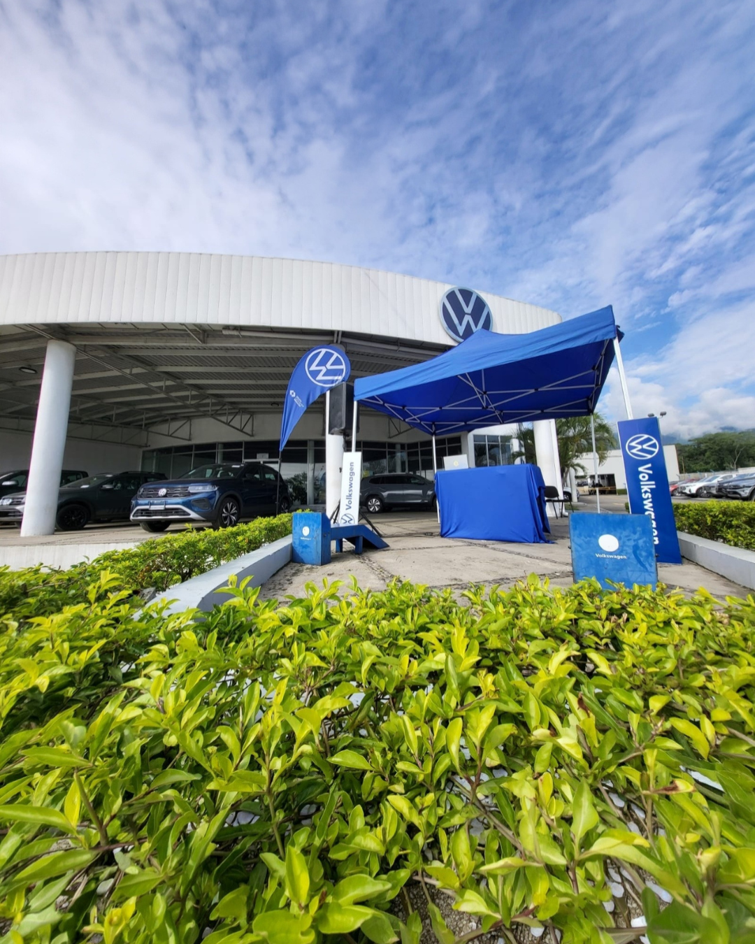 Stand corporativo Volkswagen en exterior con estructura promocional azul y presencia visual de marca